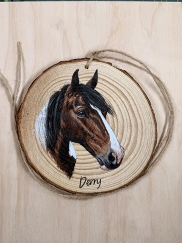 Pet portraits on wood slices. A white terrier dog portrait on a woodslice